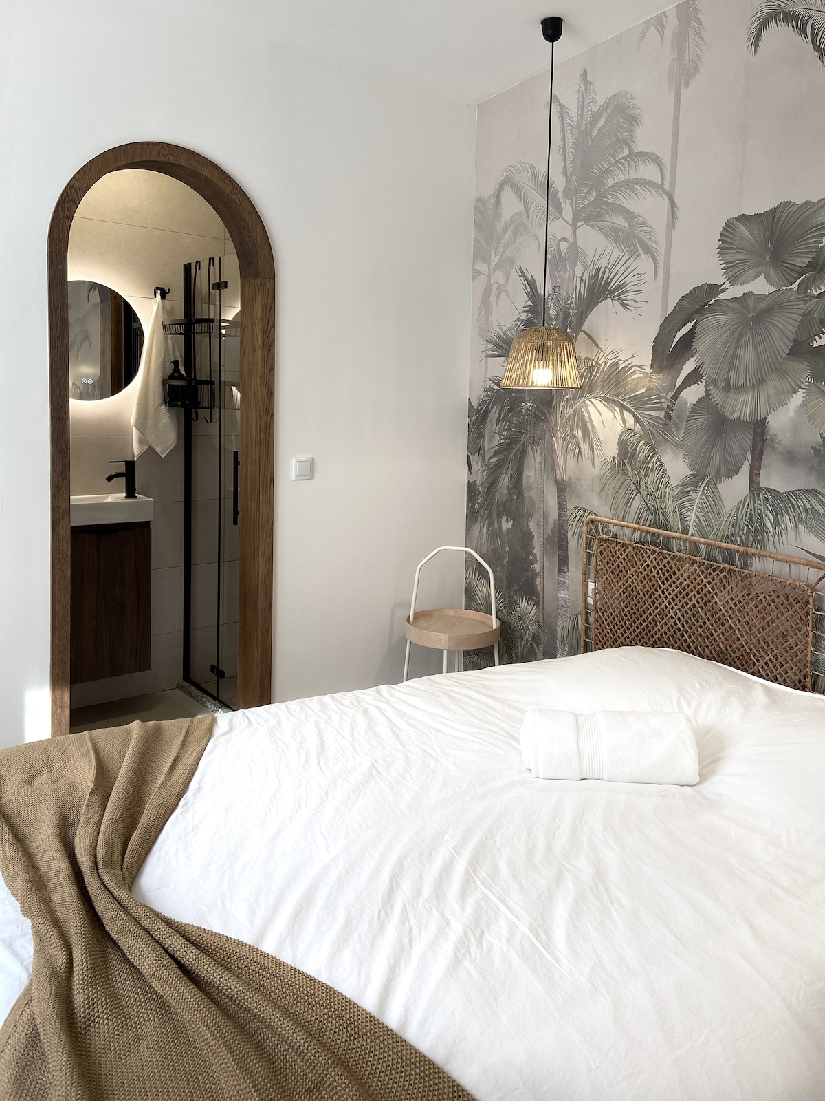 Suite-style bedroom with arched ensuite bathroom view