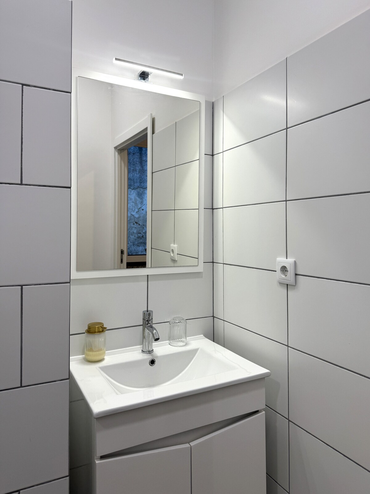 Minimal white-tile bathroom