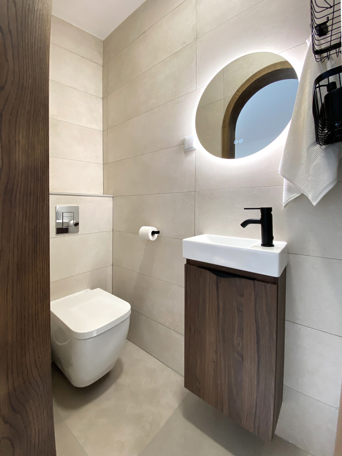 Premium bathroom with backlit mirror and walnut vanity