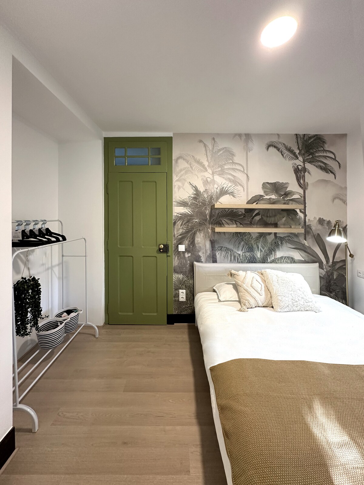 Bedroom with palm wall and storage