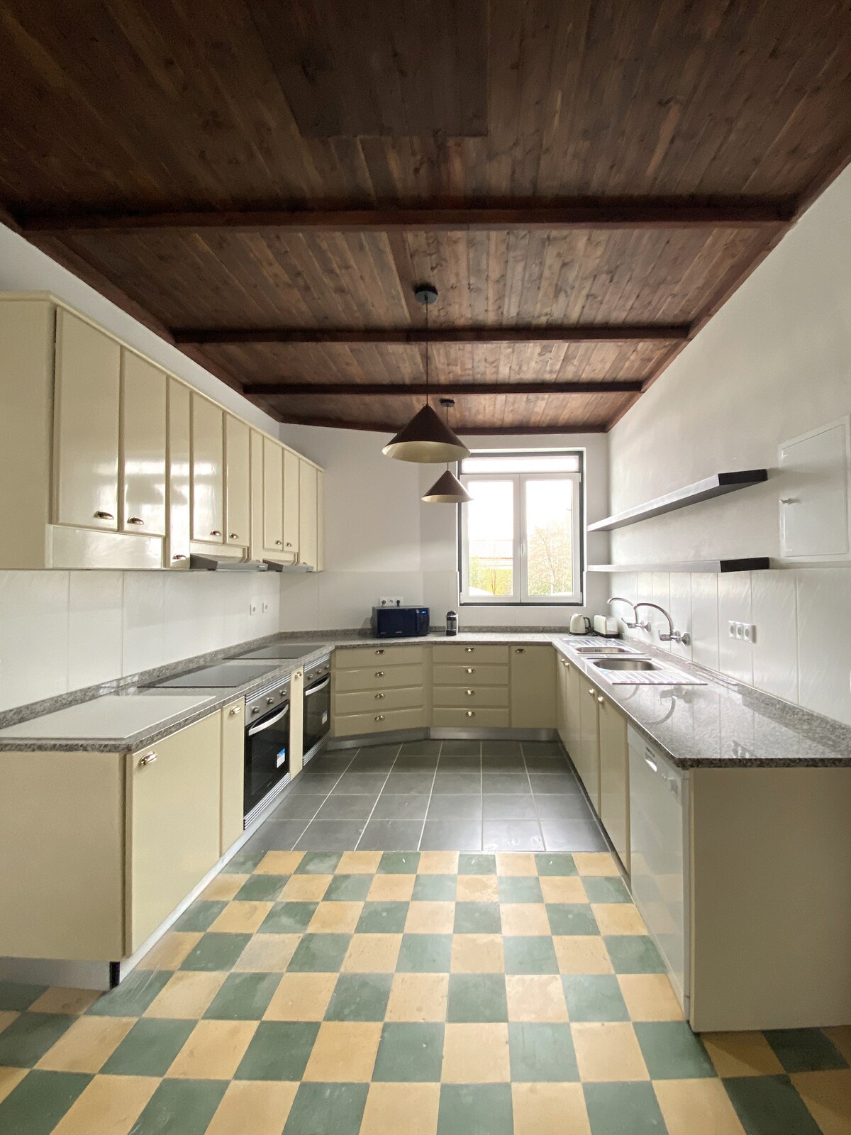 Full kitchen with wood ceiling and granite counters
