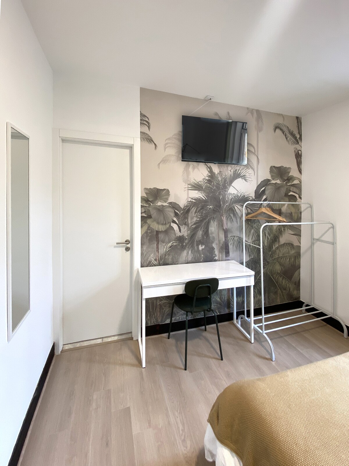 Workspace with palm mural and wall TV