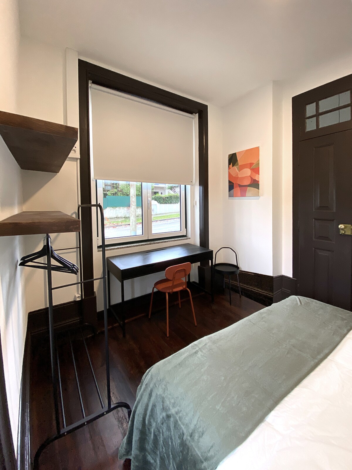 Dark-floor bedroom with orange chair