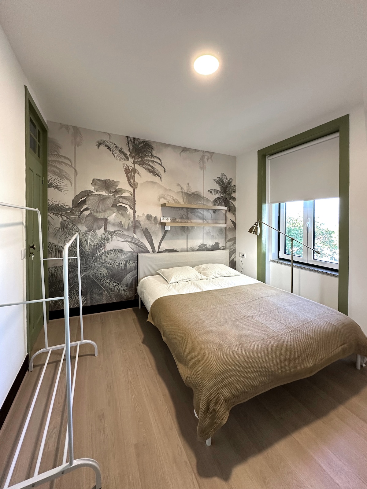 Bedroom with monochrome palm mural