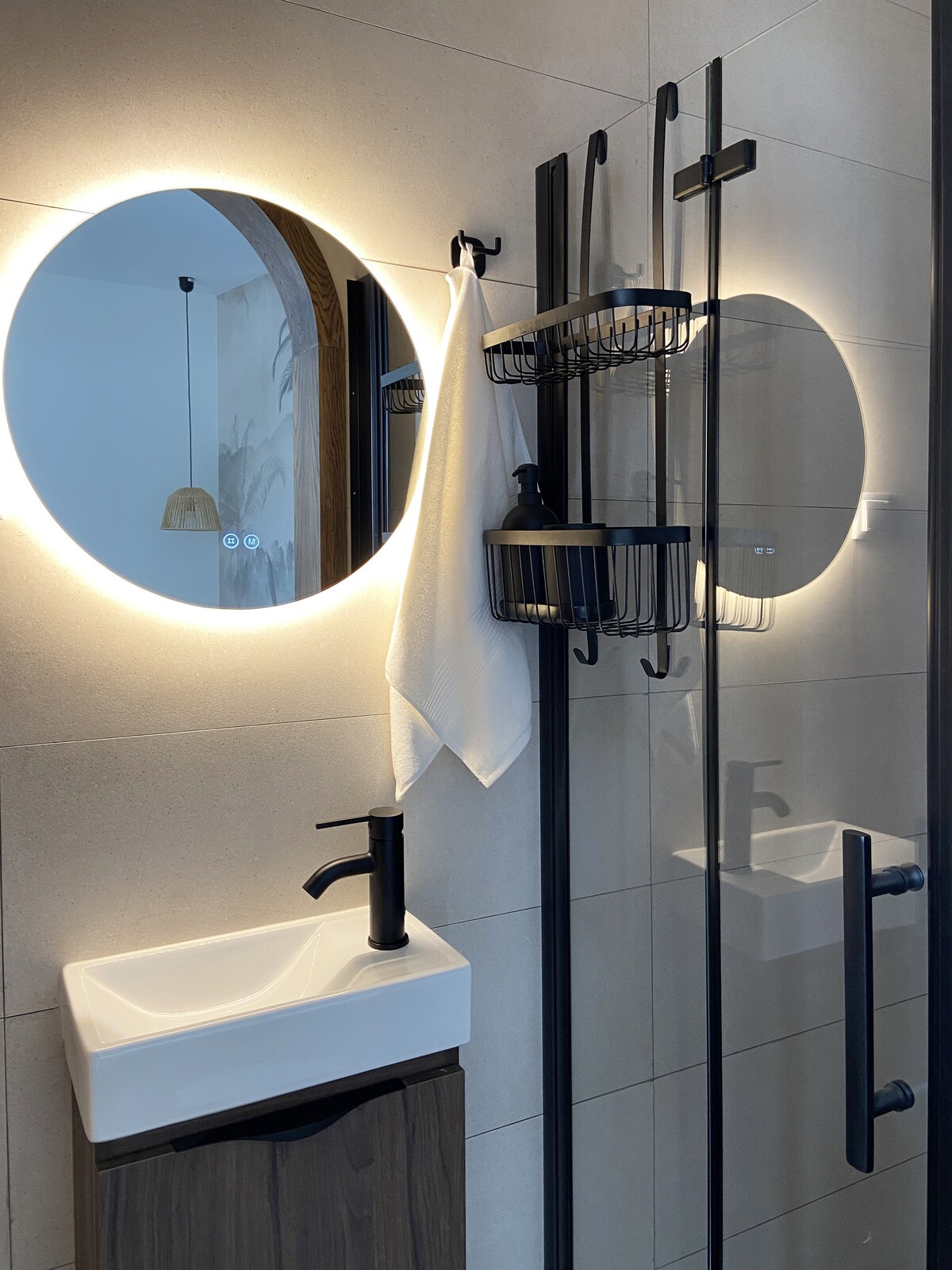 Backlit round mirror bathroom detail